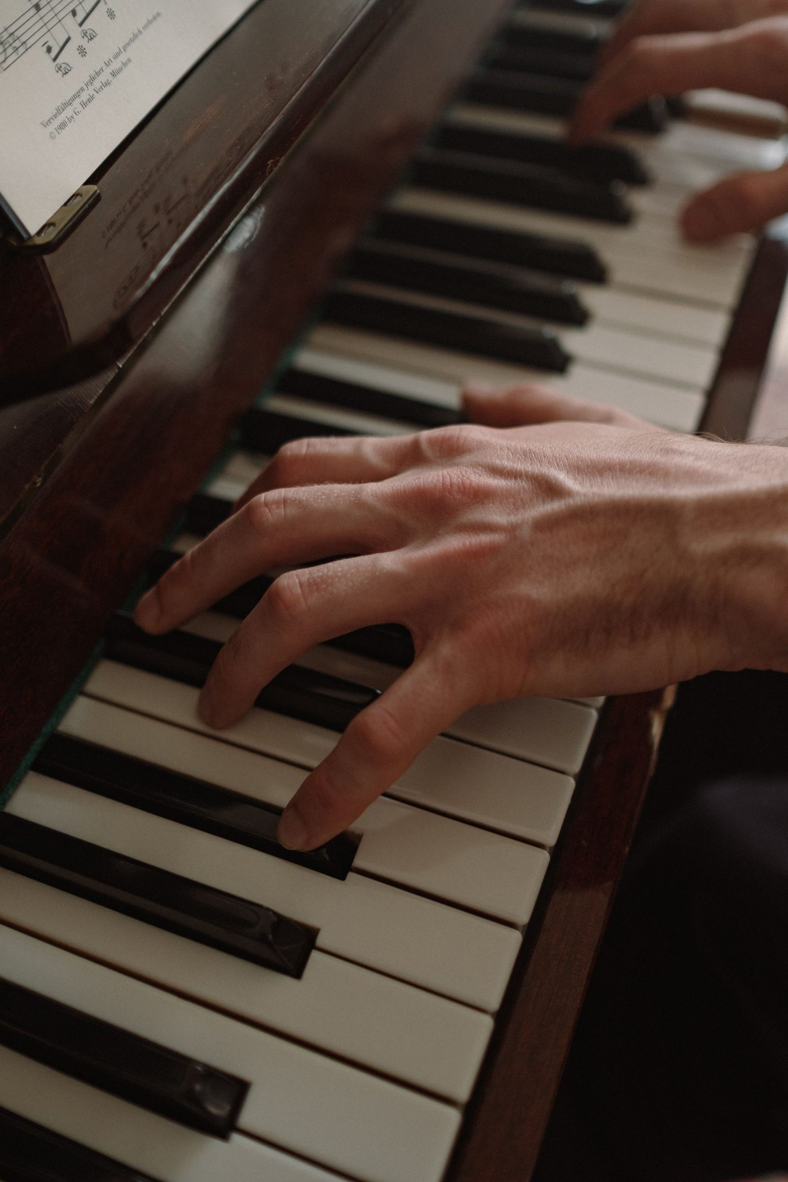 Hands playing a piano